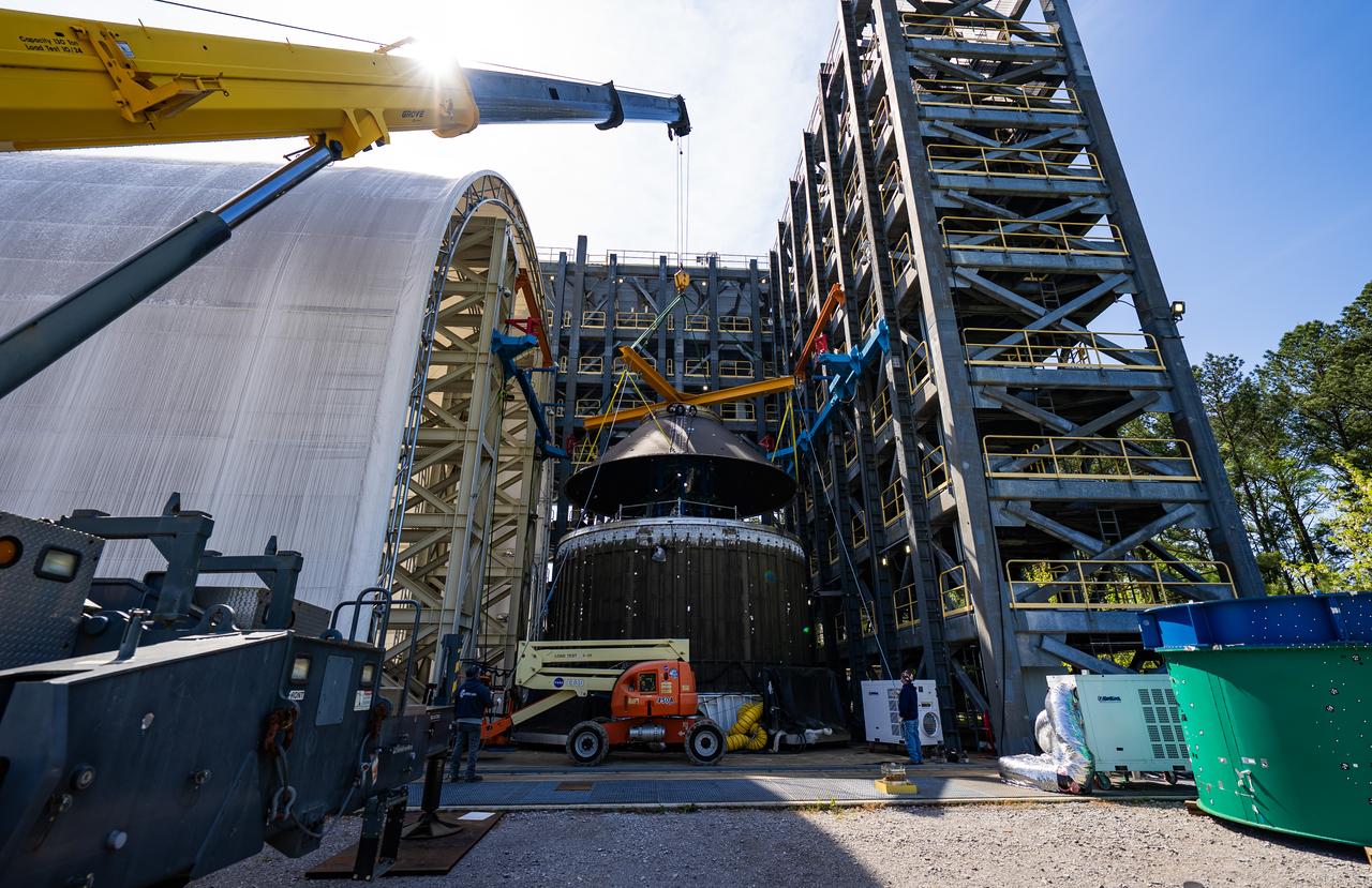 Technicians at NASA’s Marshall Space Flight Center in Huntsville, Alabama, are seen in these images taken April 17, 2025, moving the payload adapter test article from Building 4697 to Building 4705 for storage. This move marks the end of structural testing for the test article. Next, engineers will complete the qualification article and conduct additional for further testing before building the final flight hardware. Manufactured at Marshall, the test article underwent extensive and rigorous testing to validate the design before engineers finalized the configuration for the flight article. The newly completed composite payload adapter is an evolution from the Orion stage adapter to be used in the upgraded Block 1B configuration of the SLS (Space Launch System) rocket, debuting with Artemis IV.